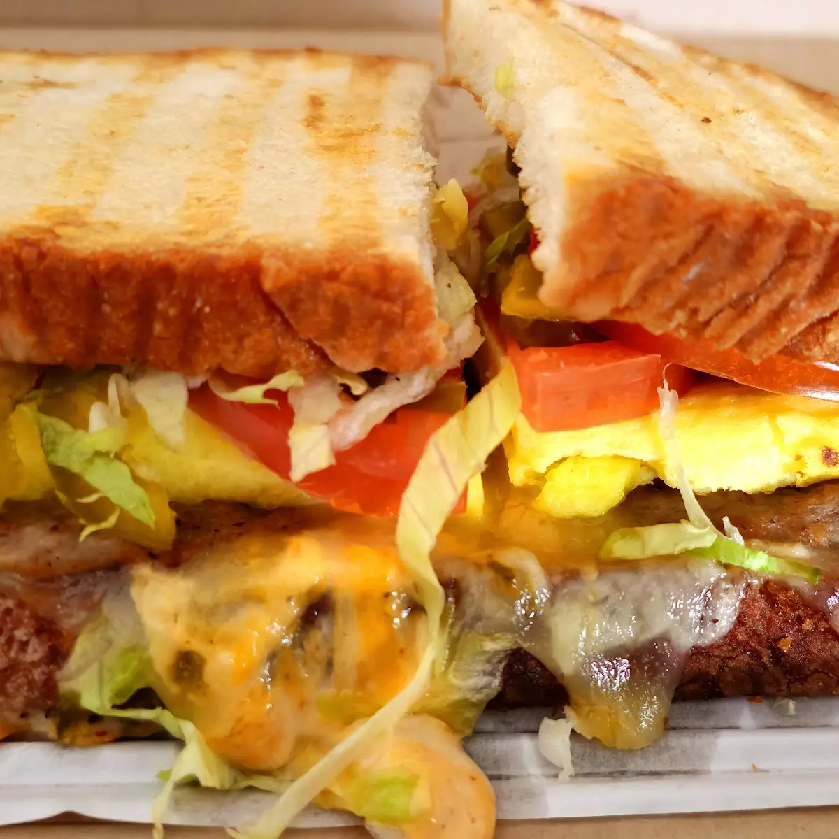 Chipotle Sauce Scrambled Eggs and Sausage Panini with Lettuce Tomatoes and Sweet Pepper