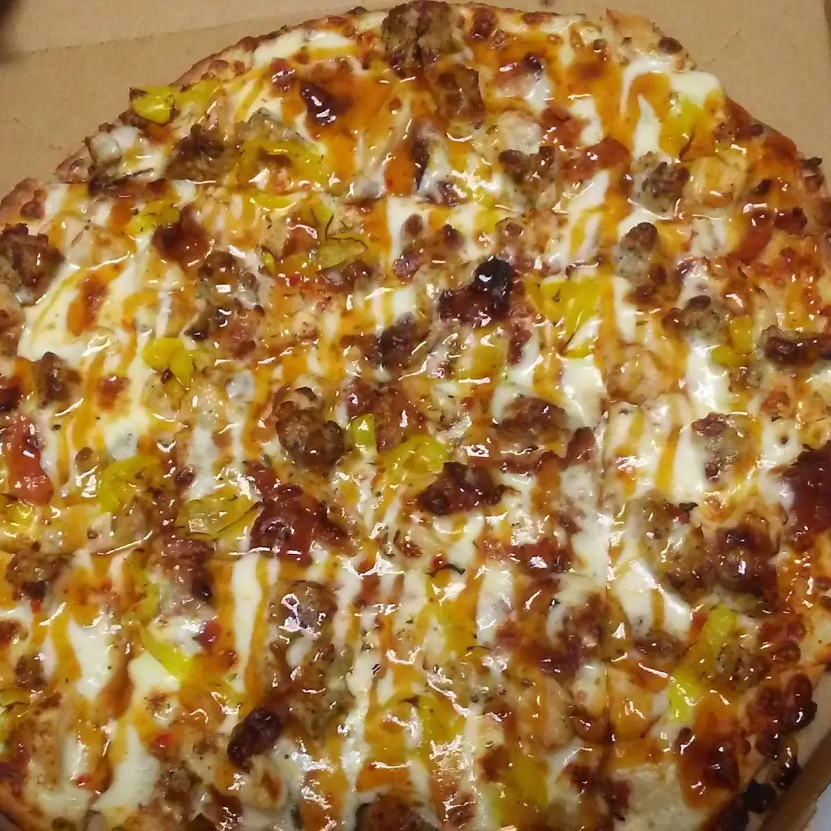 Just a Beef Pizza with Mango Habanero Sauce on It