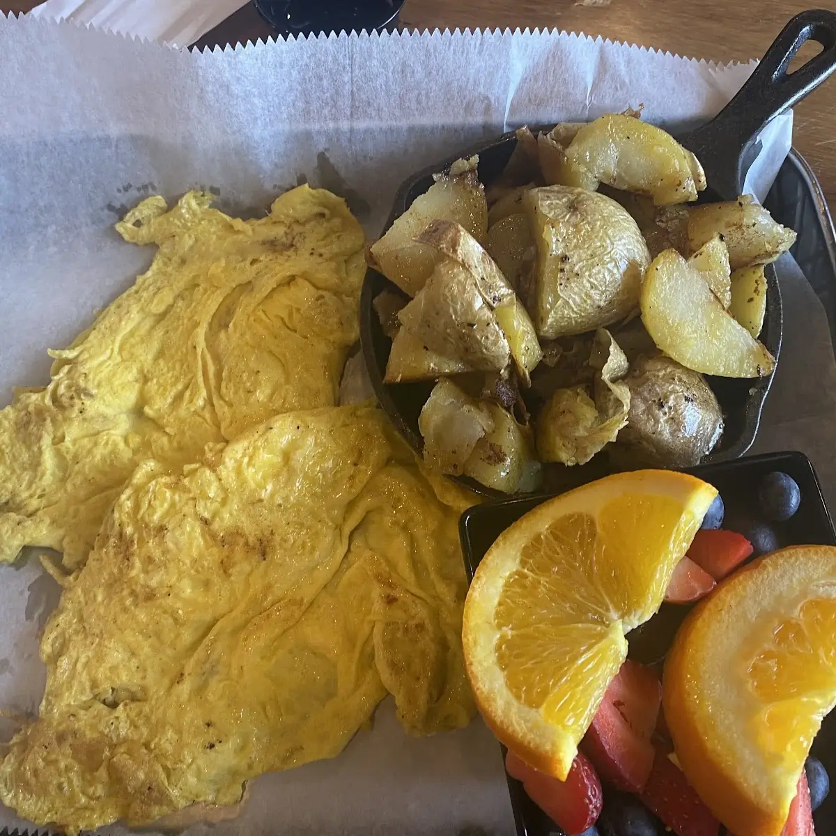Scrambled Eggs with Roasted Potatoes and Fresh Fruit