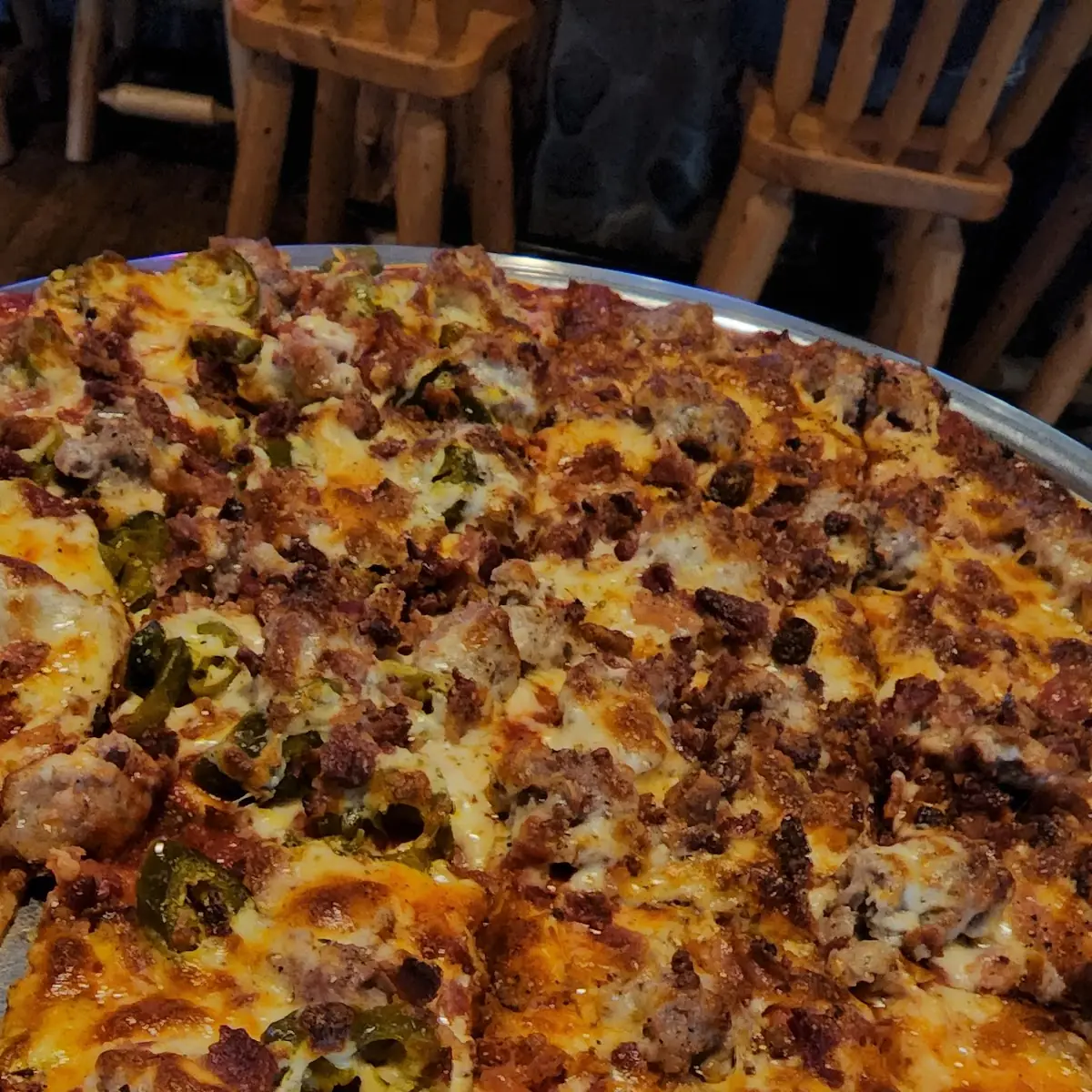 Papa Bear Meat Lovers Pizza with Jalapeños on Half