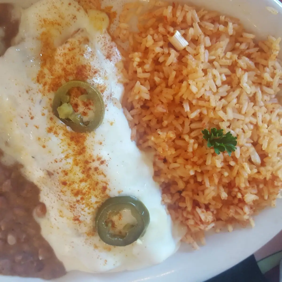 7-Two Chicken Enchiladas with Tomatillo Sauce Served with Rice and Refried Beans