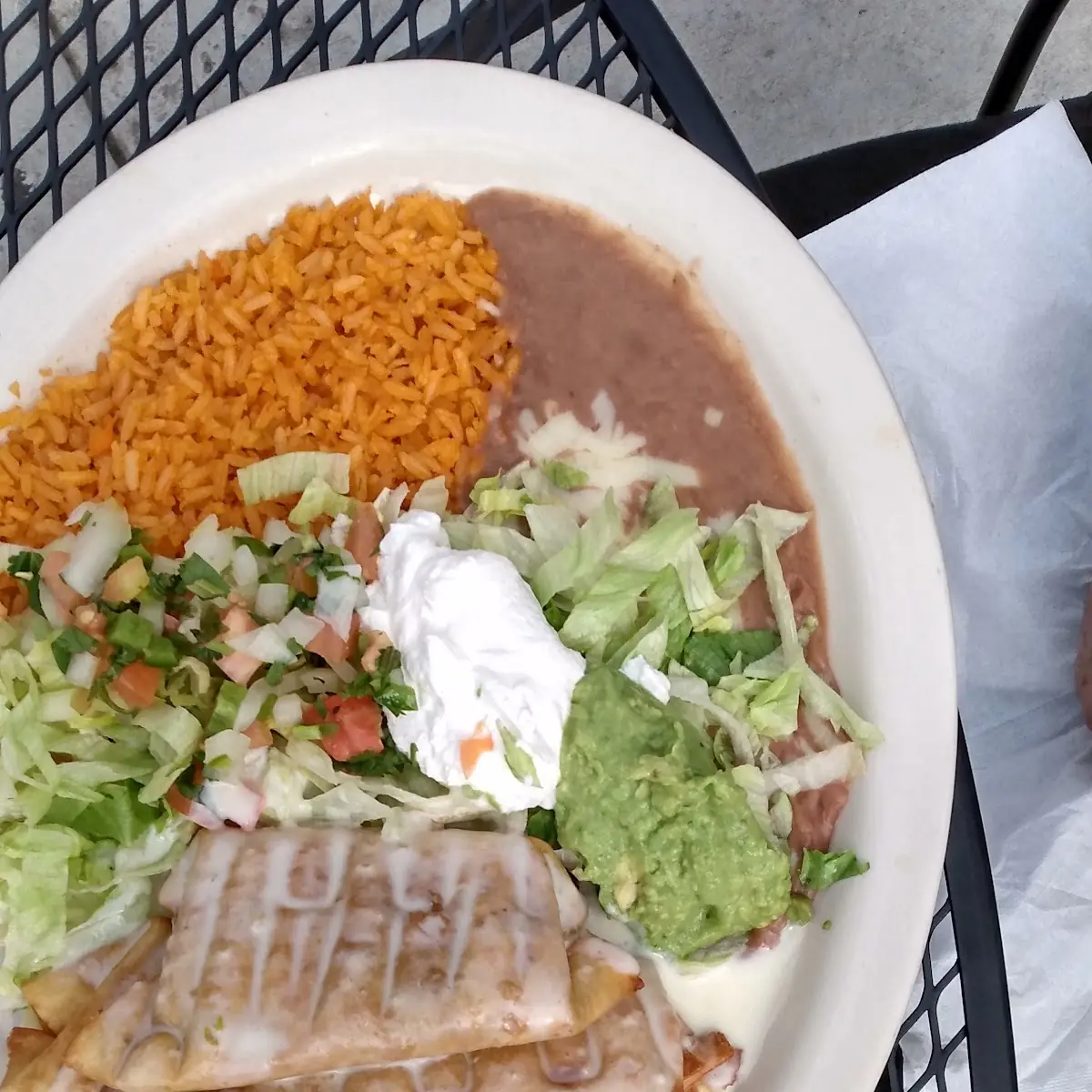 Three Tacos Mexican Rice and Refried Beans