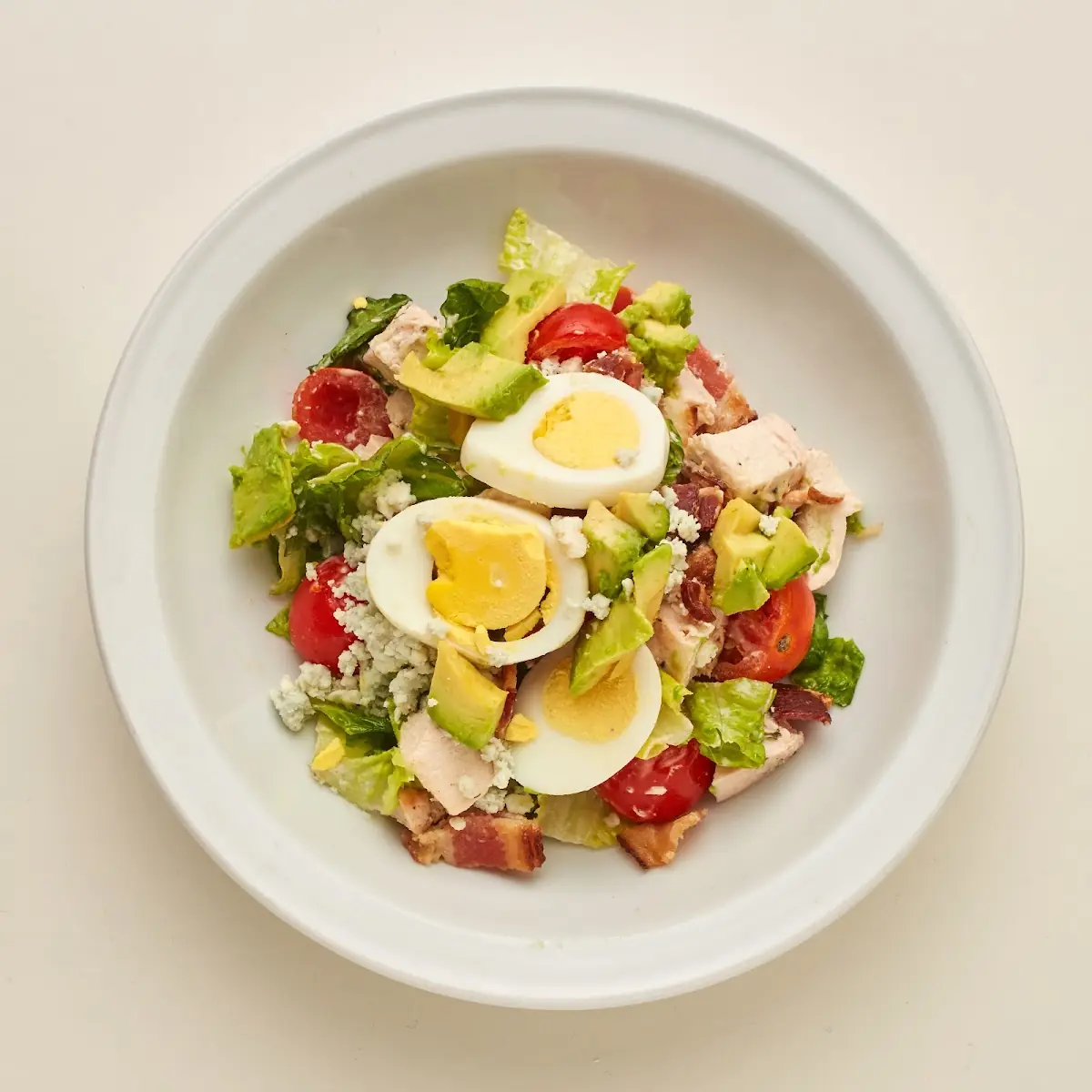Cobb Salad with Chicken Bacon Avocado Blue Cheese Tomatoes Eggs and Ranch Dressing