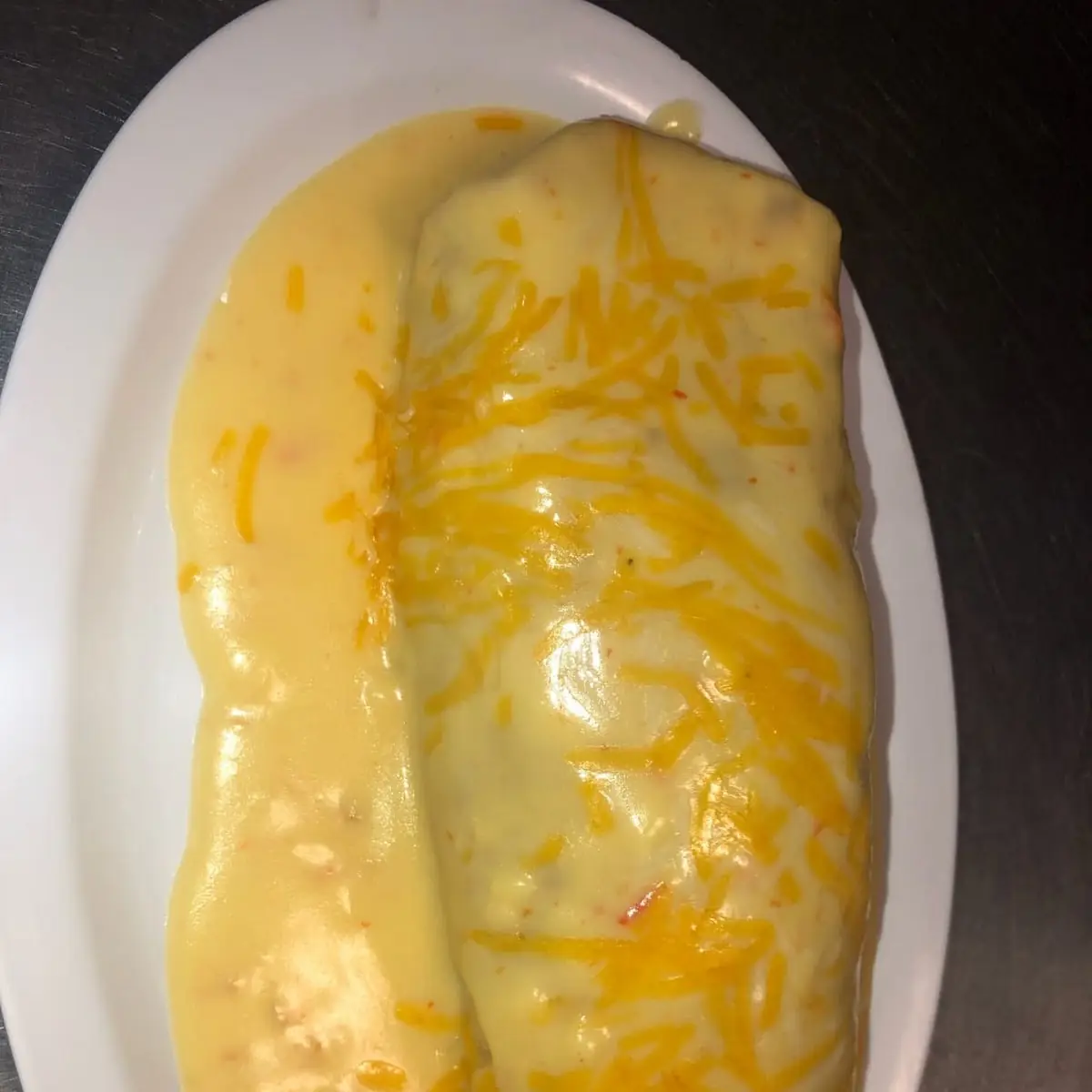 Burrito Topped Whit Cheese Sauce