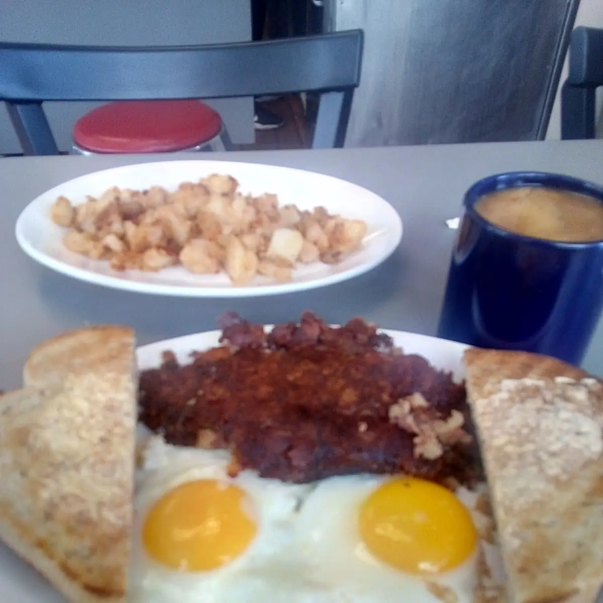 Two Eggs Basted Corned Beef Hash Rye Toast and Home Fries