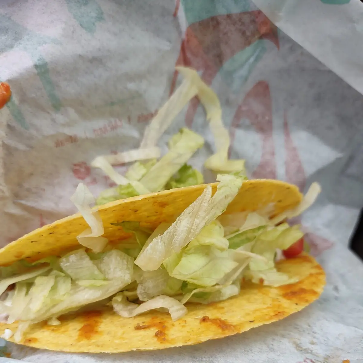Hard Shell Taco Supreme Missing Cheese and Filled with Lettuce
