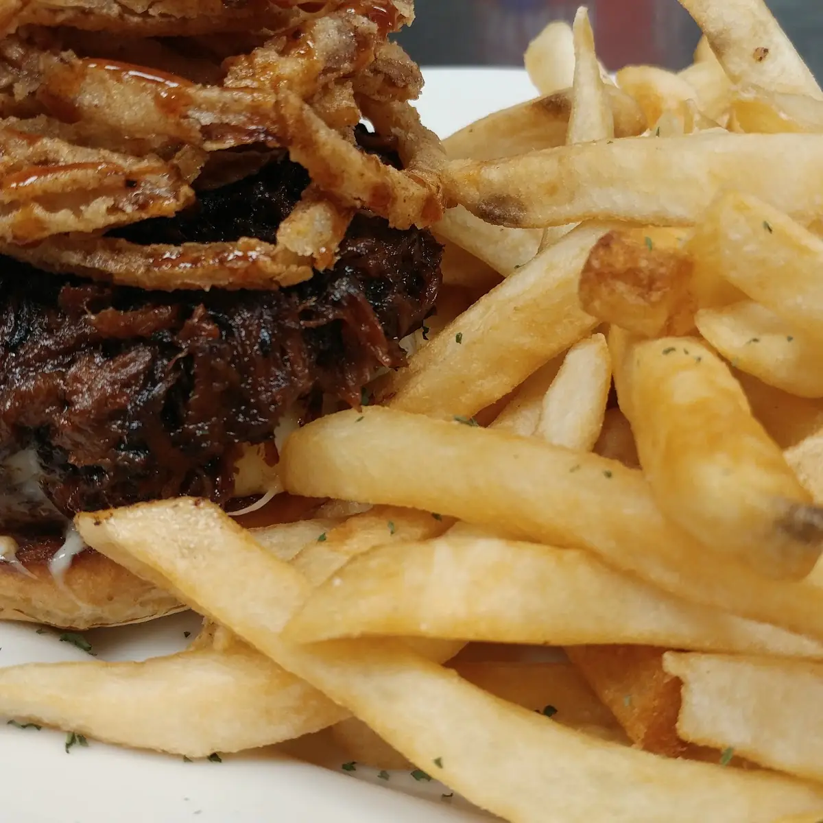 Try Our New Carolina BBQ Burger Piled High with Pulled Pork Pepper Jack Cheese and Onion Rings