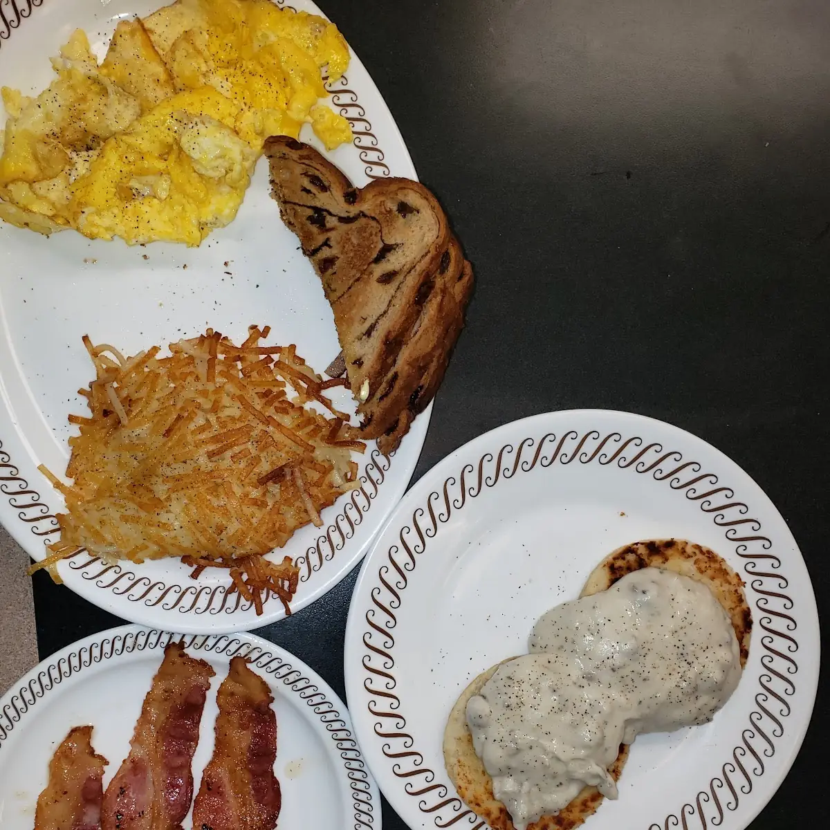 Scrambled Eggs Hasbrowns Covered an Chunked Rasin Toast Biscuits and Gravy