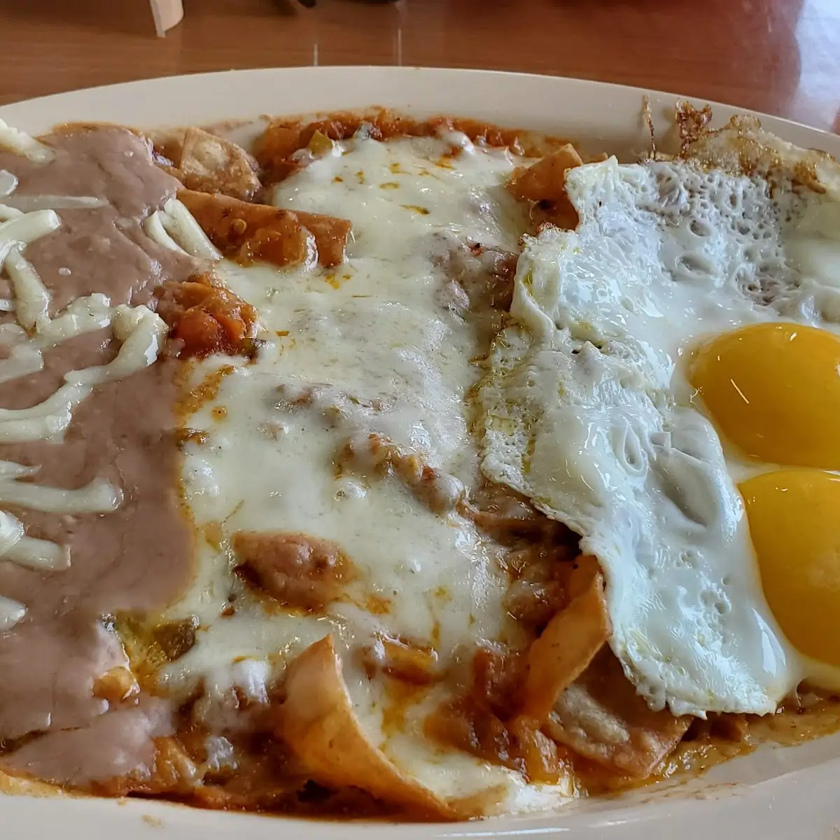 Chilaquiles with Two Eggs & Refried Beans
