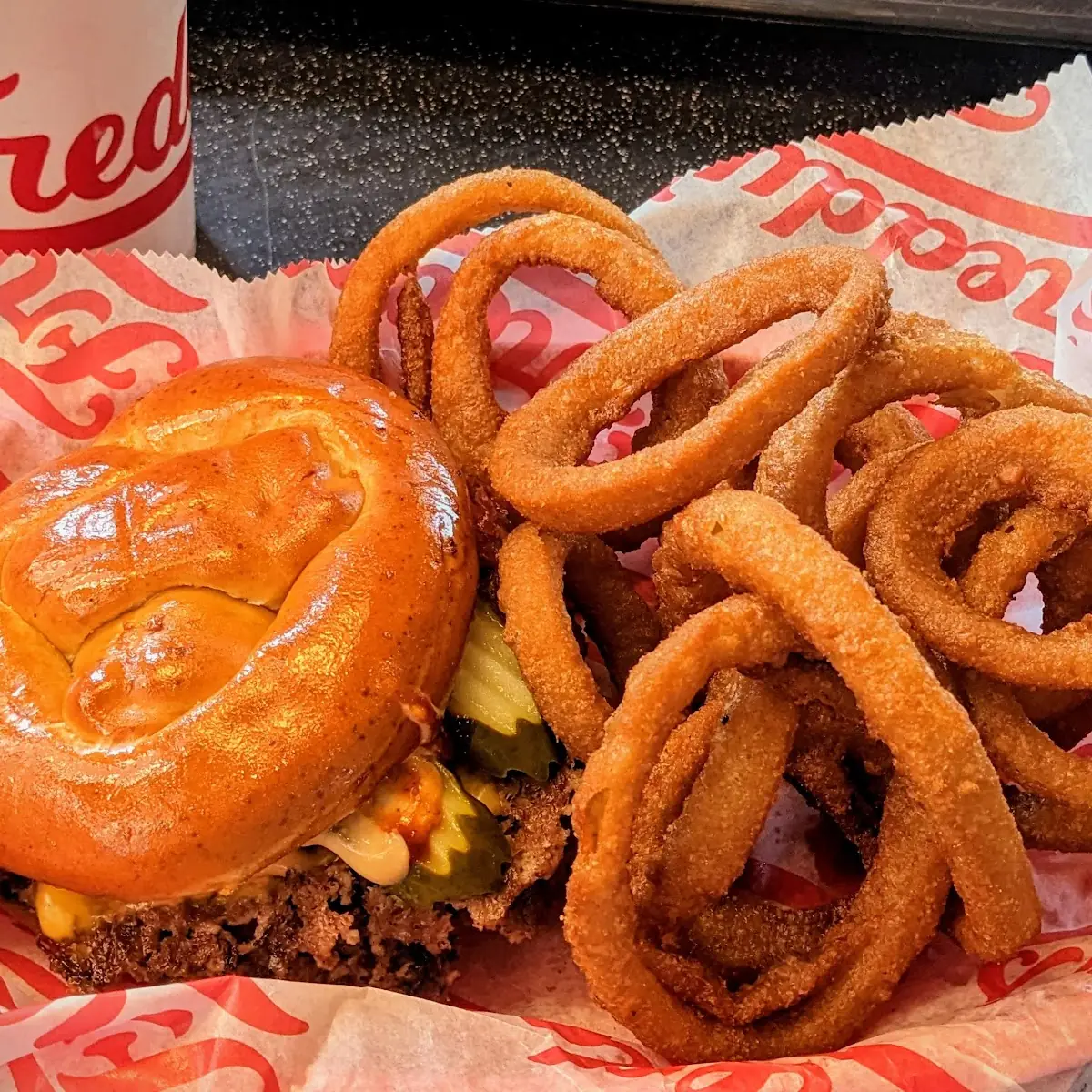 Double Cheeseburger on Pretzel Bun with Onion Rings