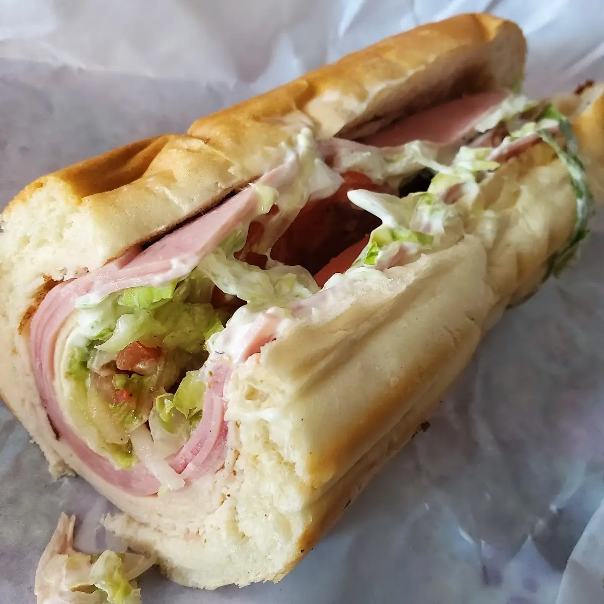 Ham and Turkey Extra Meat Provolone Lettuce Tomato Onion and Italian Dressing on White Bread