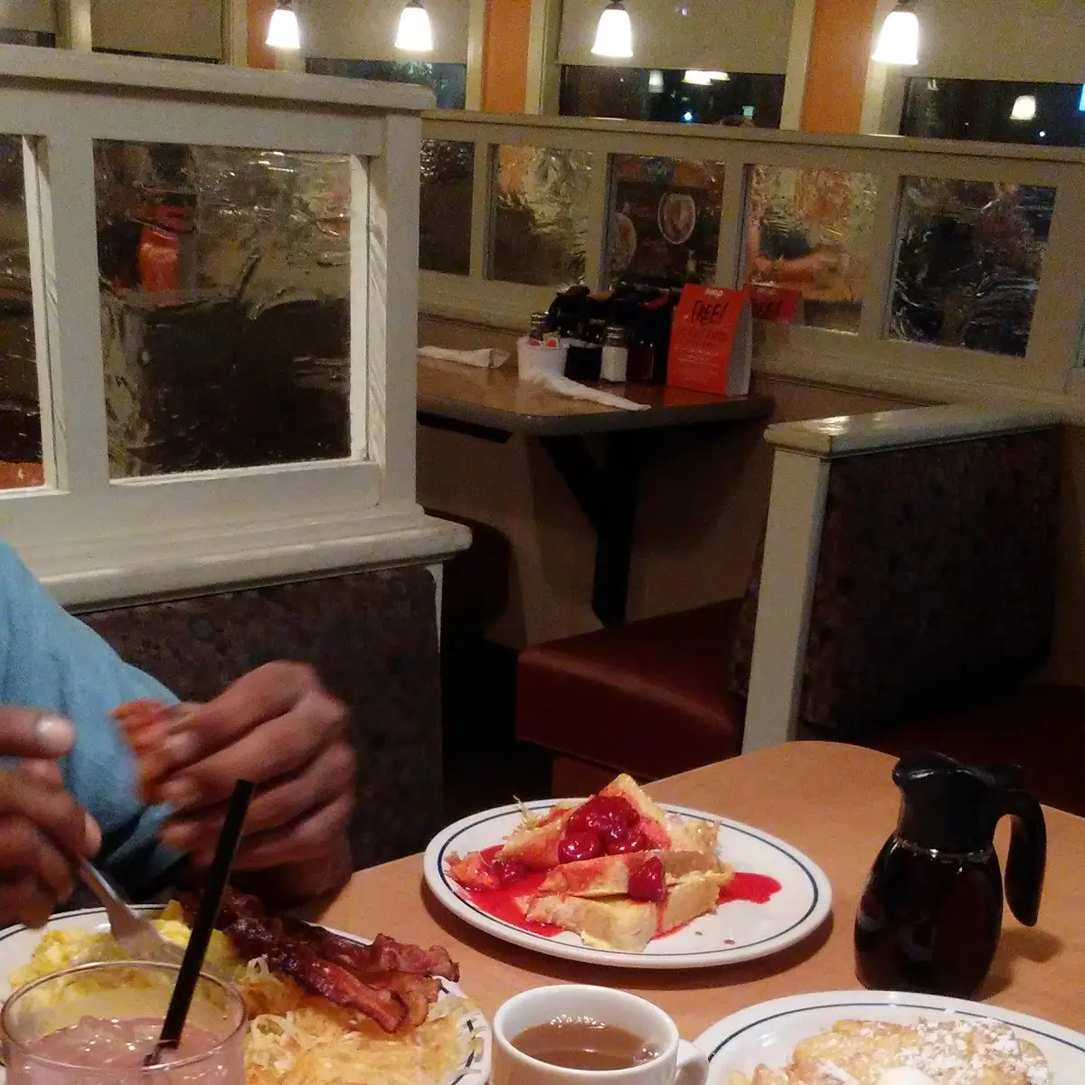 Scrambled Eggs with Cheese Hash Browns Bacon Strips Sausage Links and Strawberry Bananas Pancakes