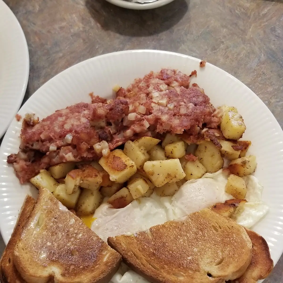 Eggs Corned Beef Hash Potatoes and Toast