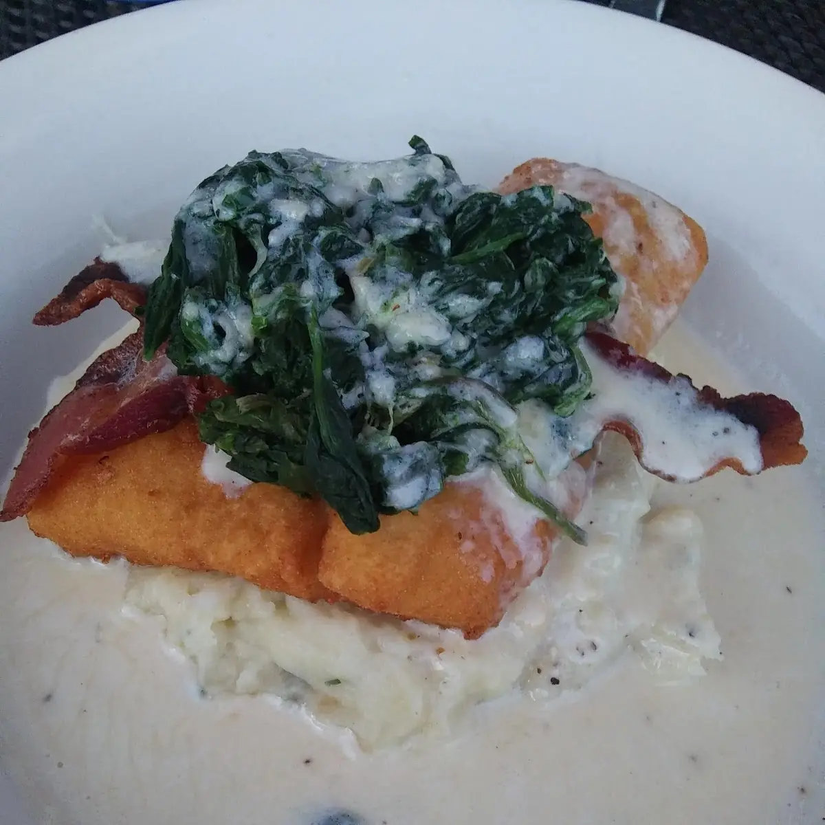 Fried Haddock over Mashed Potatoes Topped with Baked Haddock Spinach and Bacon