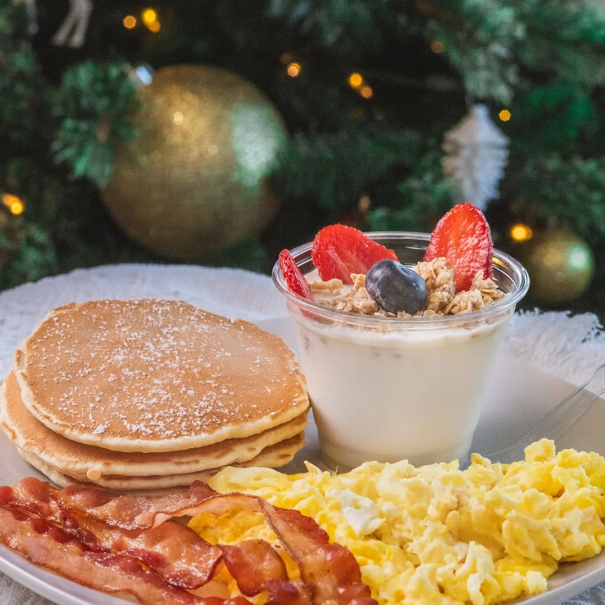 Scrambled Eggs Bacon Pancakes and Yogurt