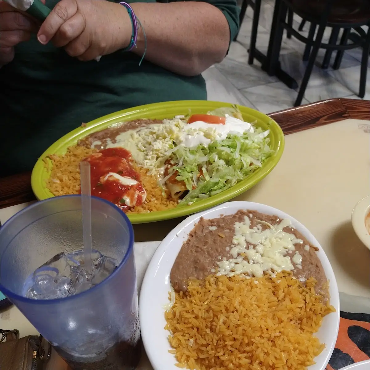 Veg 1. One Bean Burrito, One Cheese Enchilada and One Tostada with Beans, Lettuce, Sour Cream, Cheese and Tomato