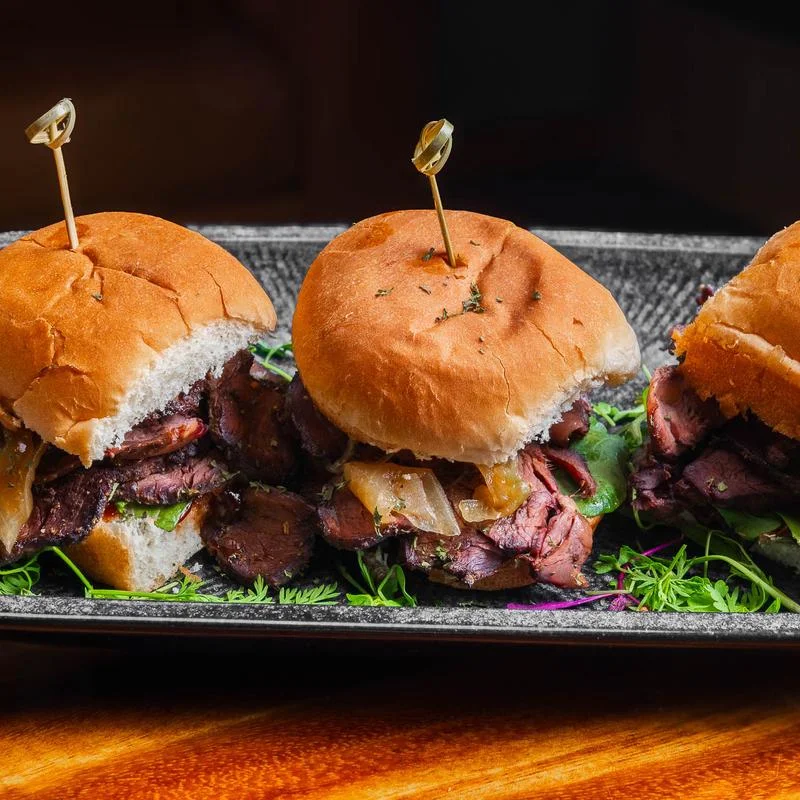 Bourbon Steak Sliders with a Bourbon Glaze Arugula and Sautéed Onions