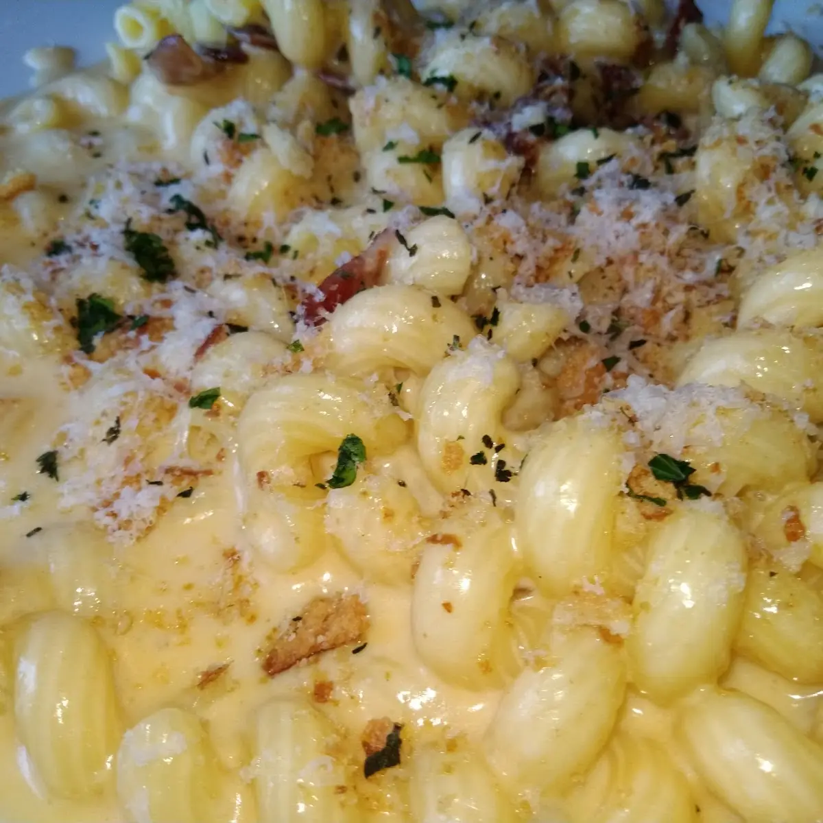 Mac and Cheese with Bacon Parmesan Cheese Raining Down on It