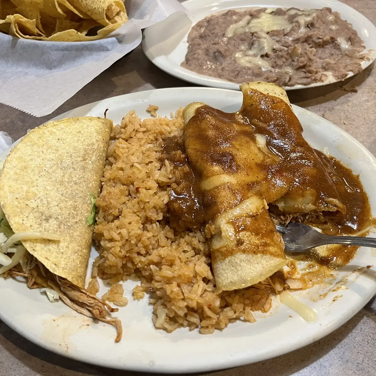 Chicken Enchiladas Rice and Refried Beans