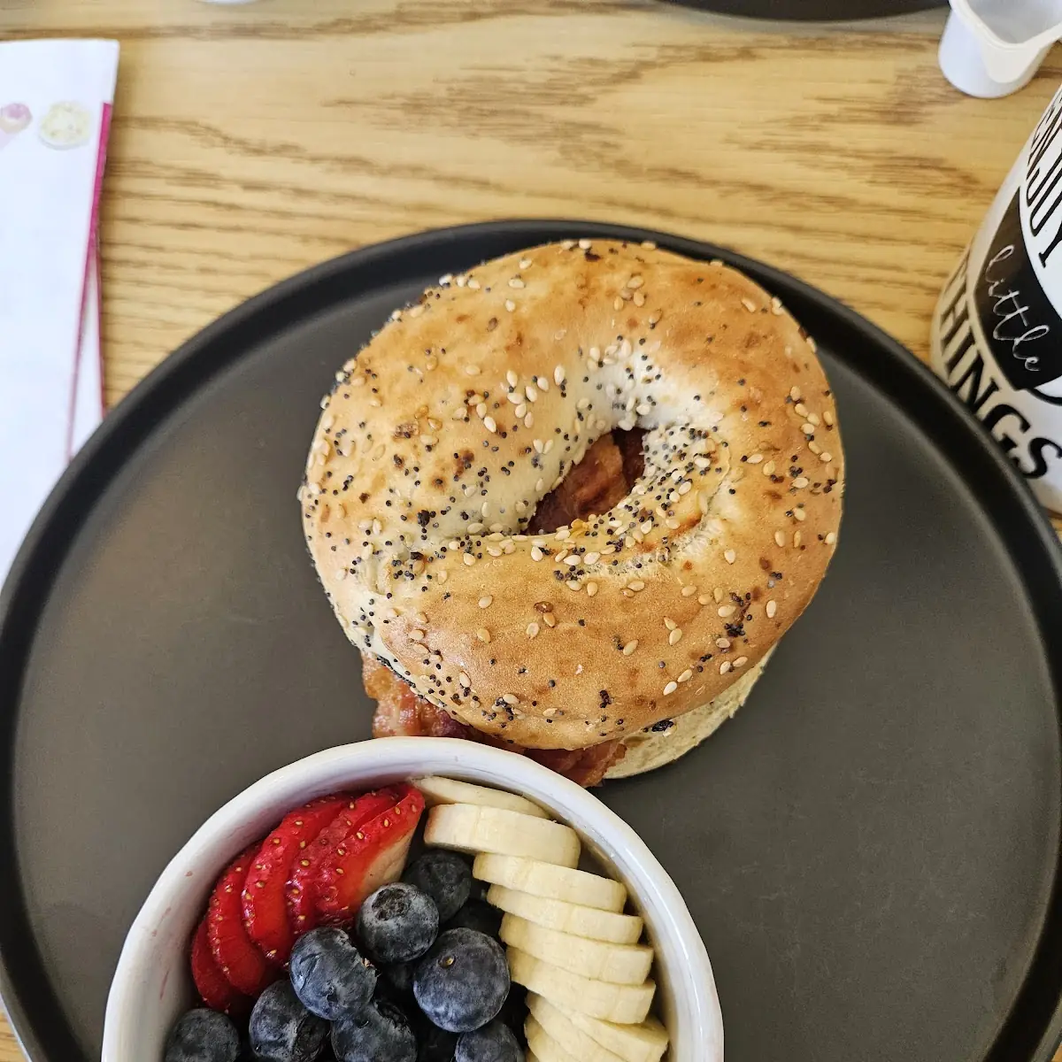 Loaded Everything Bagel with Egg Cheese and Bacon with a Side of Fresh Fruit