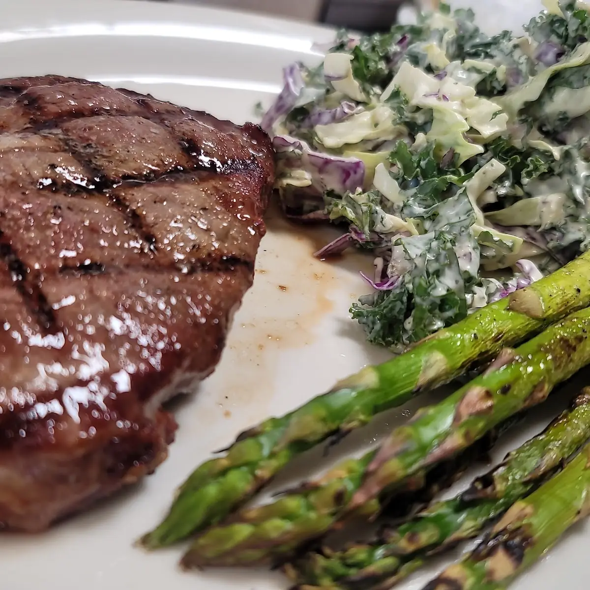Ribeye Steak Medium Rare with Kale Salad with House Dressing to Die for and Asparagus