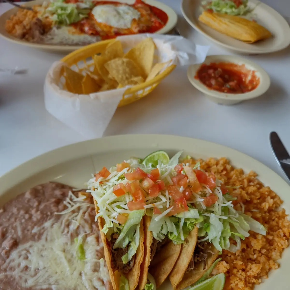 Three Hard Shell Brisket Tacos with Rice and Beans