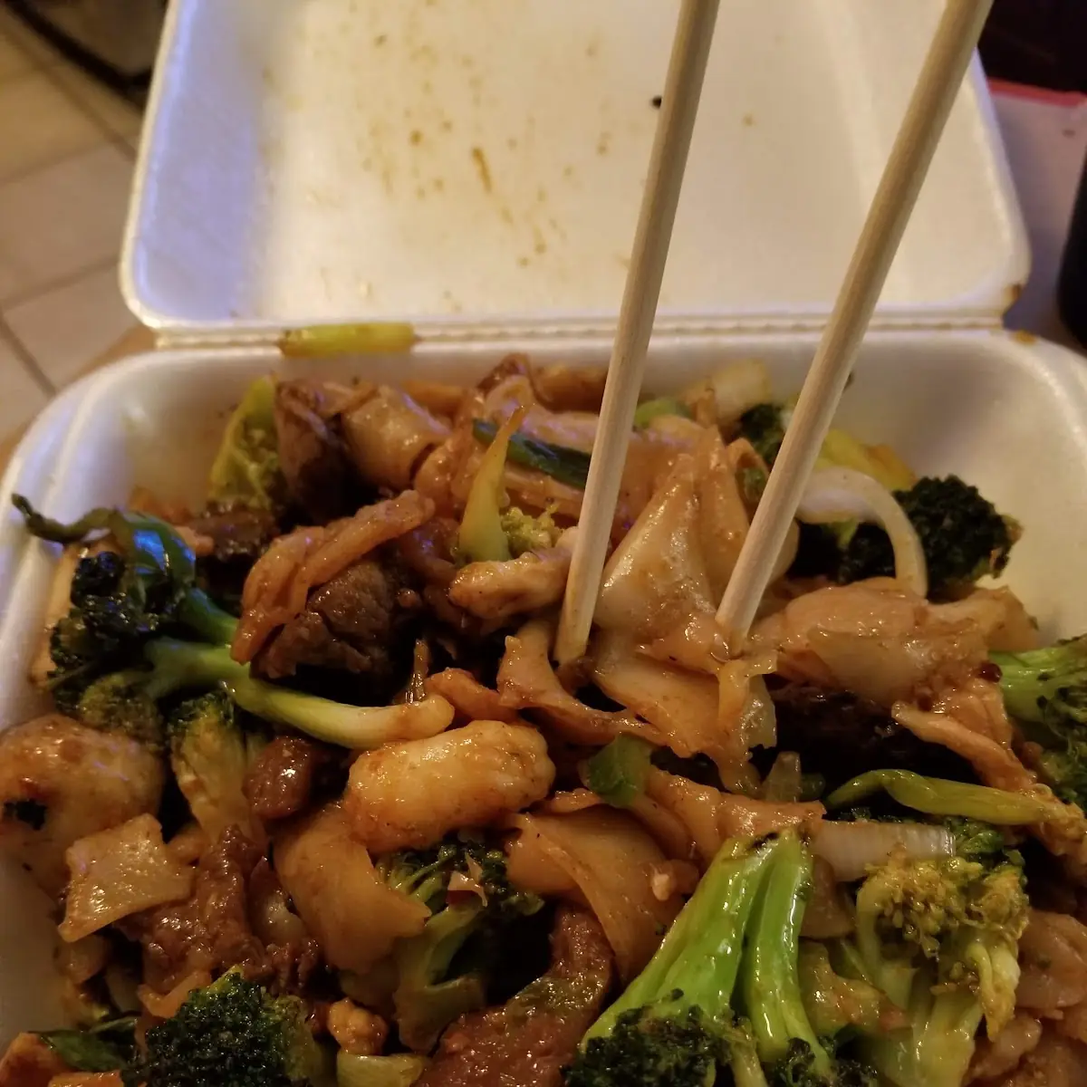 Flat Rice Noodles with Stir Fried Chicken Beef Shrimp and Veggies in Spicy Basil Sauce