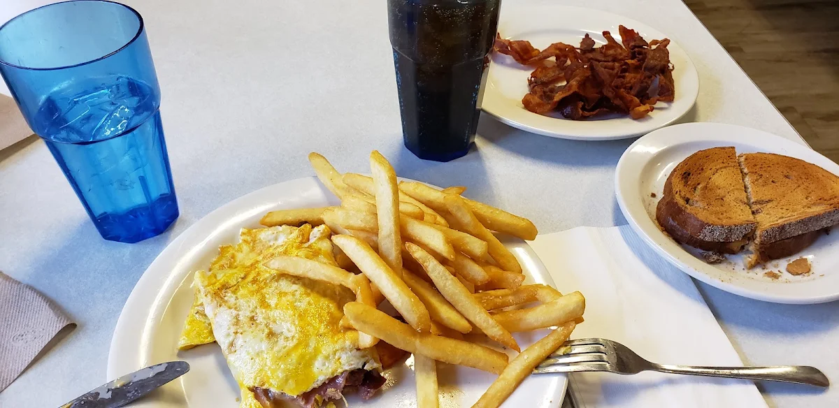 A Ham & Cheese Omlett Crispy Bacon Fries and Rye Toast