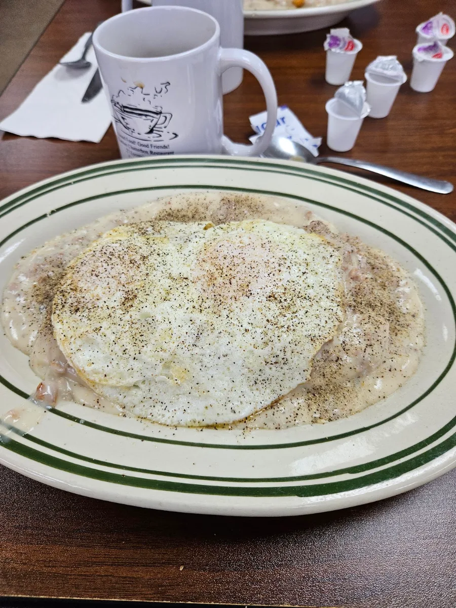 Biscuit and Gravy with Eggs over Medium on Top