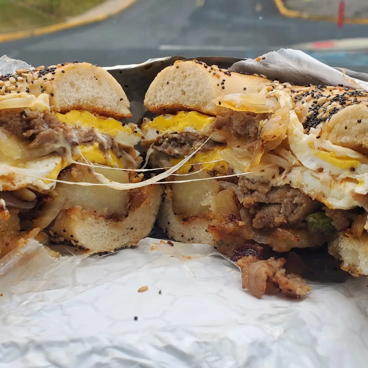 Steak Egg and Mozzarella with Home Fries on an Egg Everything Bagel Toasted
