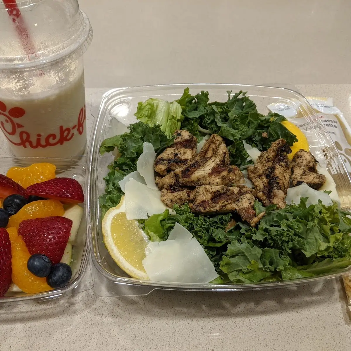 Lemon Kale Caesar Salad with Grilled Nuggets Fruit Cup Frosted Lemonade