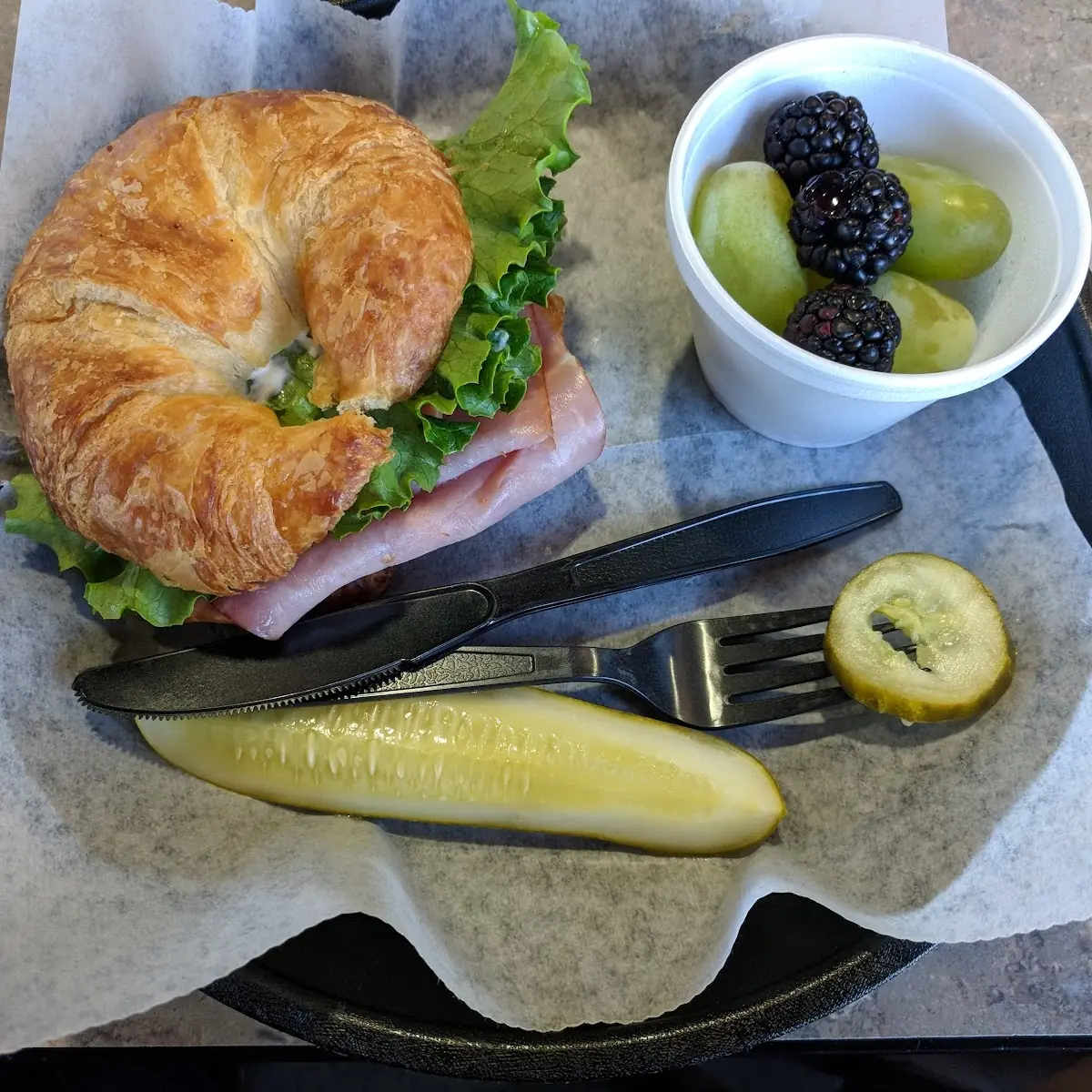 Ham Croissant Sandwich with a Pickle and Fruit Cup