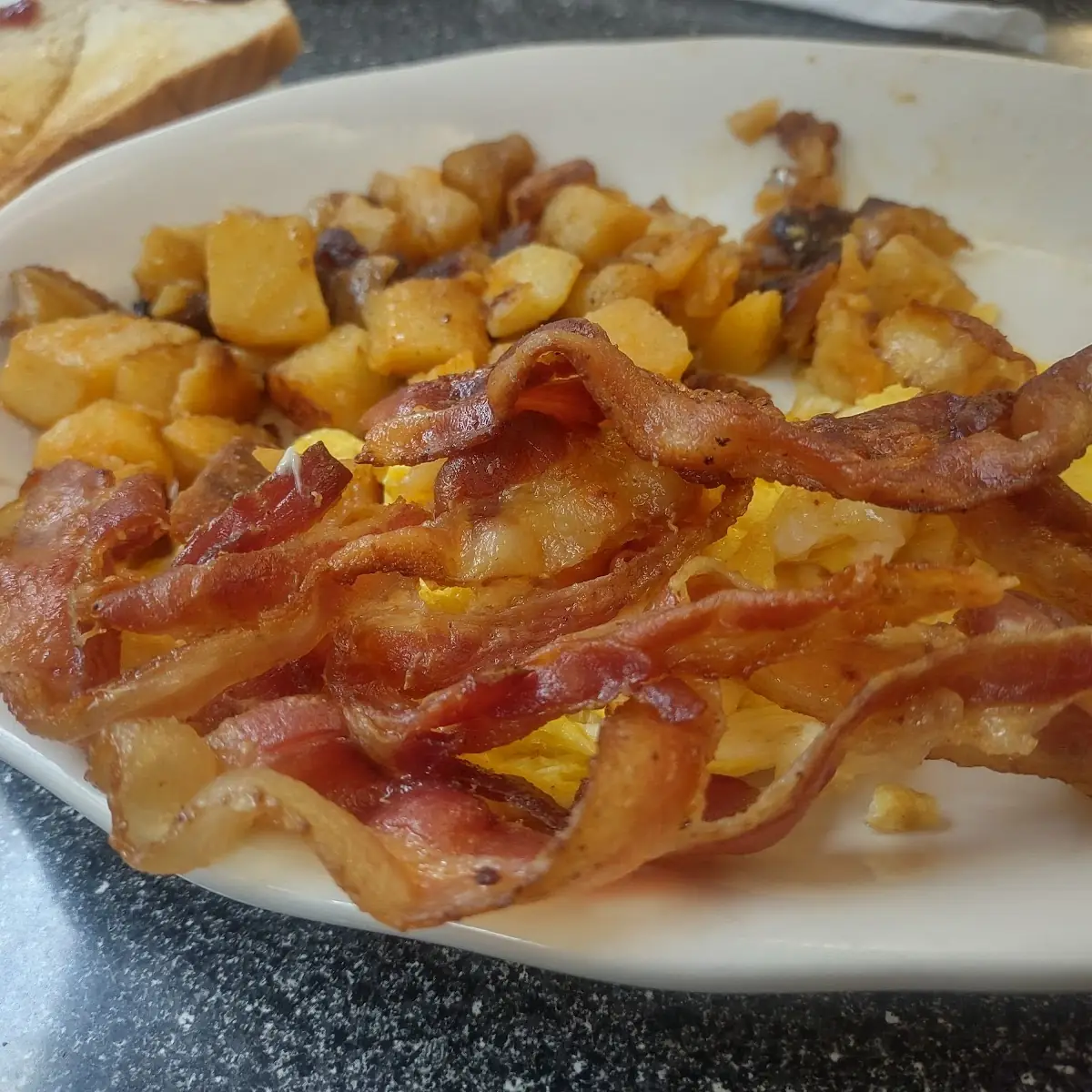 Two Eggs over Easy Bacon Home Fries and Toast