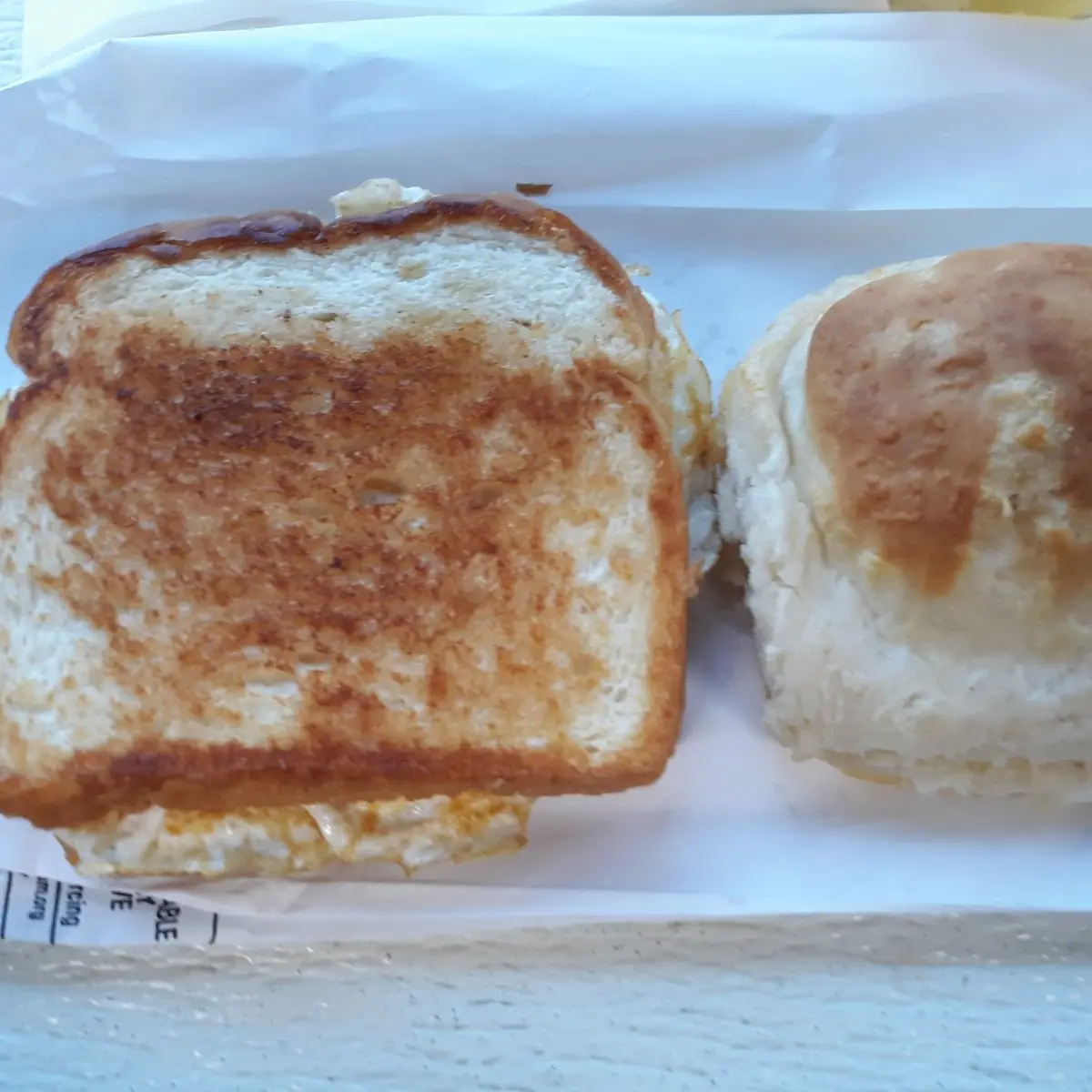 Double Egg Sandwich on Toasted Bread and a Cheese Biscuit