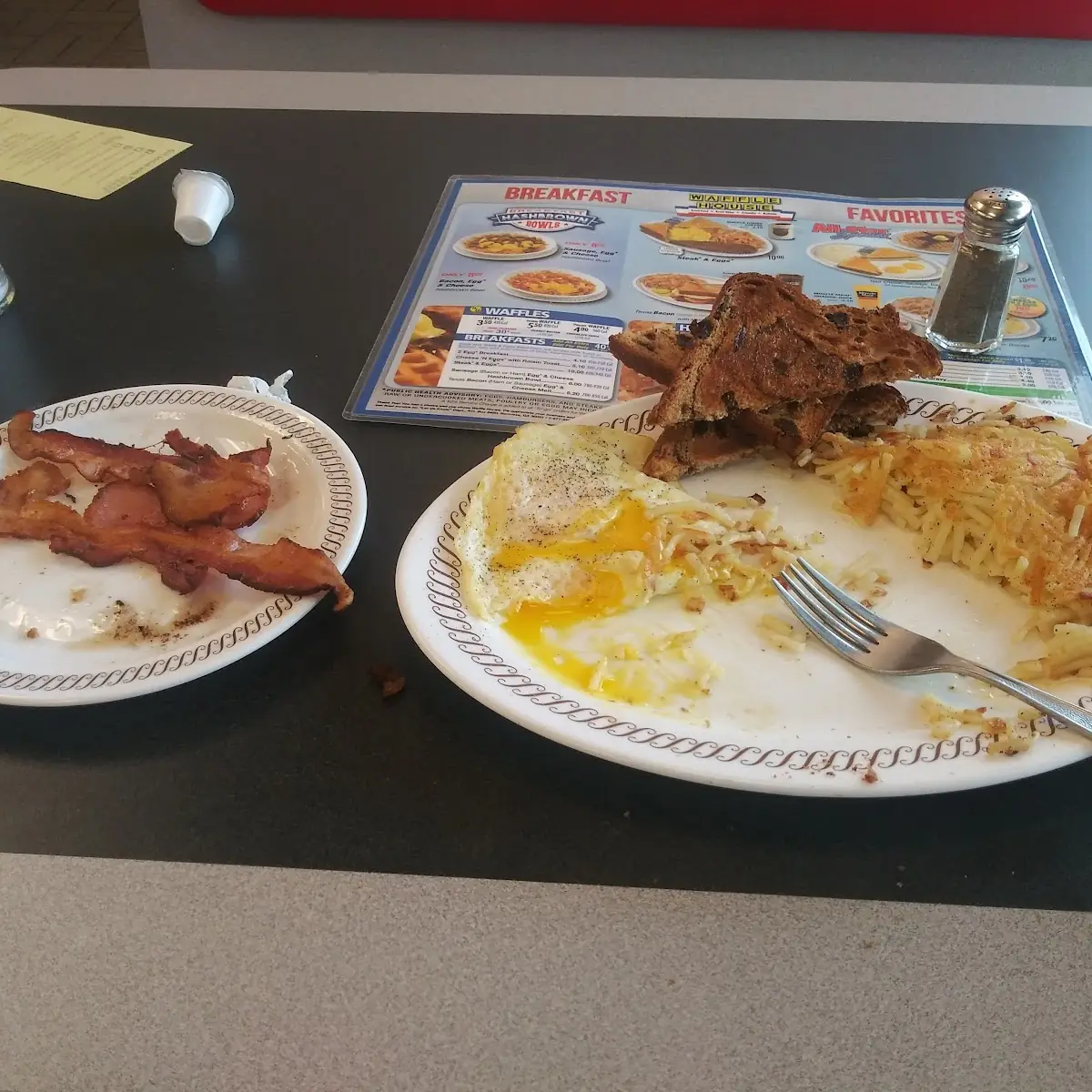 Bacon Eggs over Medium Hash Browns with Sauteed Onions and Raisin Toast