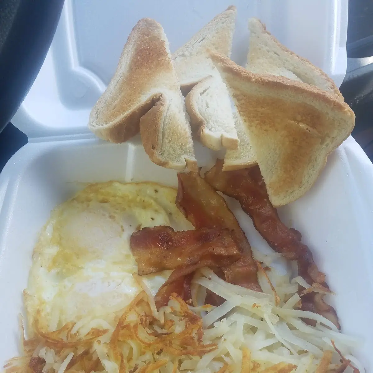 Eggs over Medium with Hash Browns Bacon and White Toast