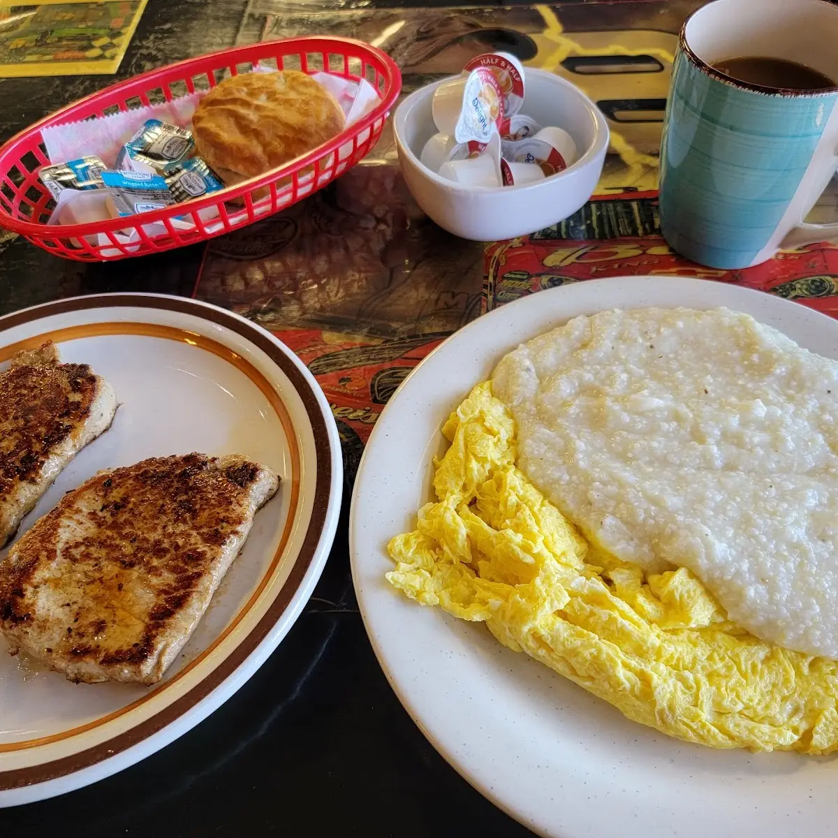 Scrambled Eggs Grits Pork Chops Biscuits and Coffee