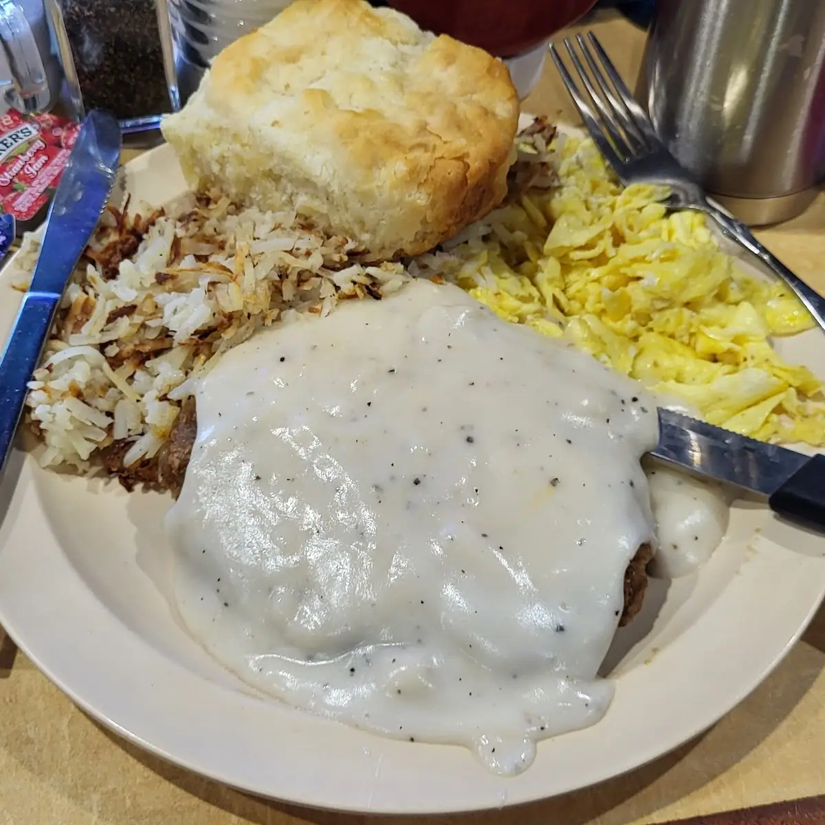 Chicken Fried Steak with Scrambled Eggs Hashbrowns & Biscuit