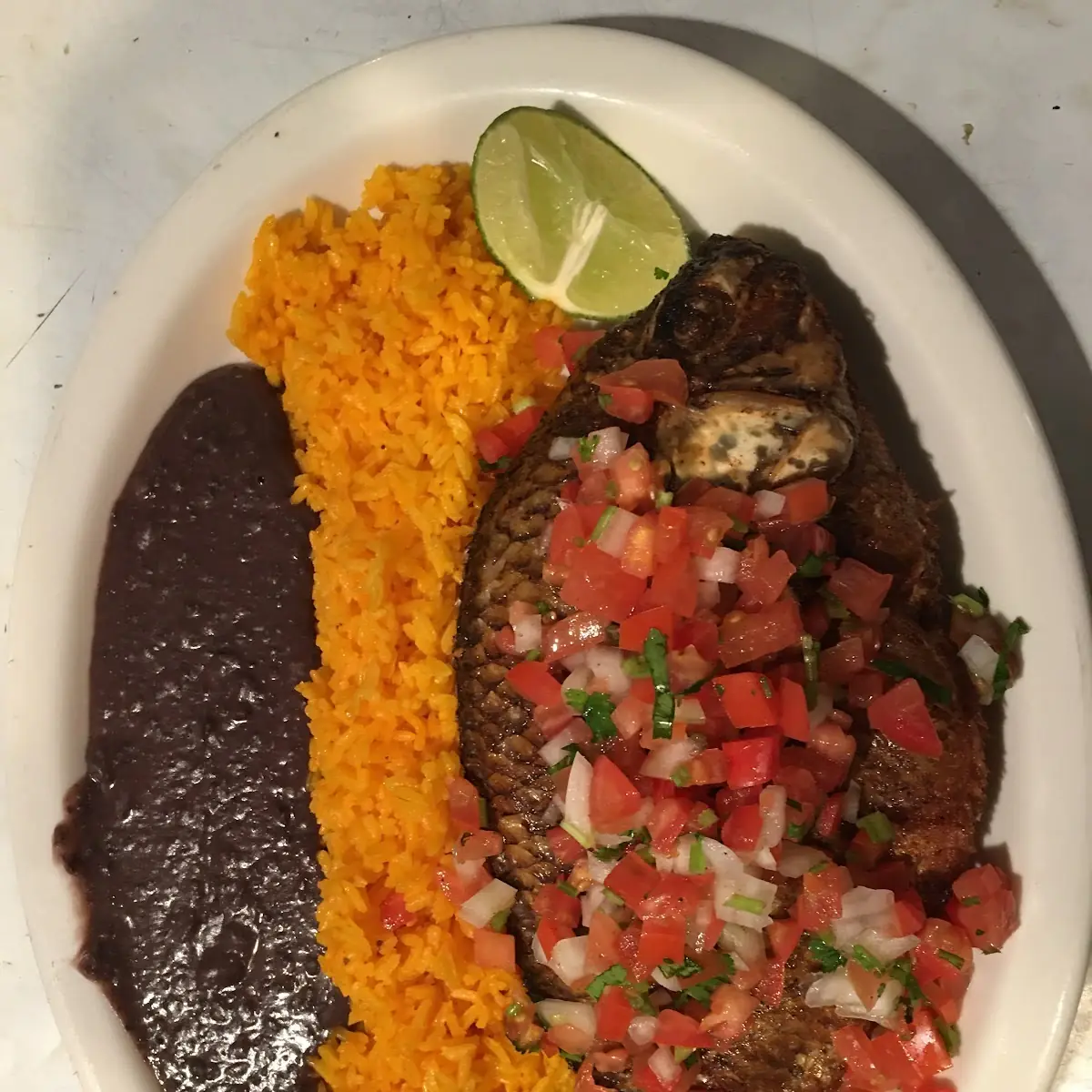 Fried Mojarra Served with Rice and Beans