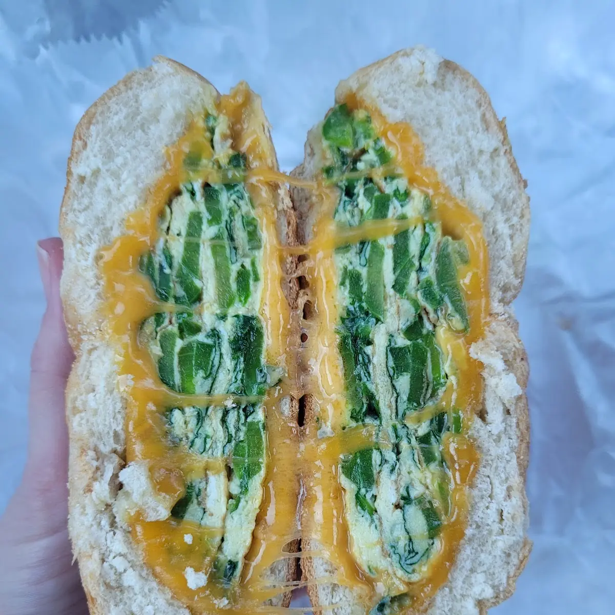 Scrambled Eggs Spinach and Cheddar Cheese on a Roll