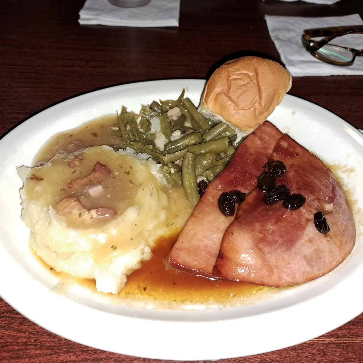 Baked Ham with Rum Raisin Sauce Mashed Potatoes and Gravy Green Beans and Dinner Roll