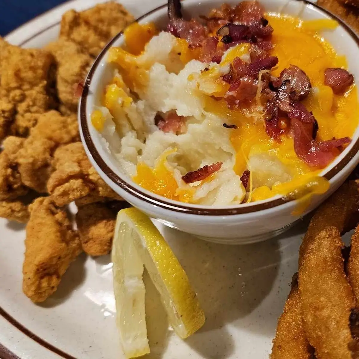 Gator Tail with Loaded Mashed Potatoes and Onion Rings