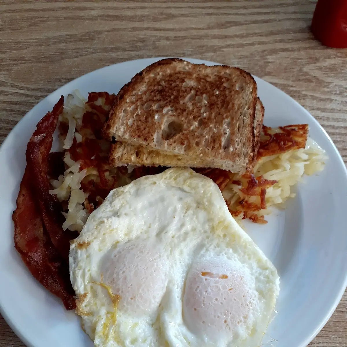 Over Easy Eggs Hash Browns Bacon and Toast