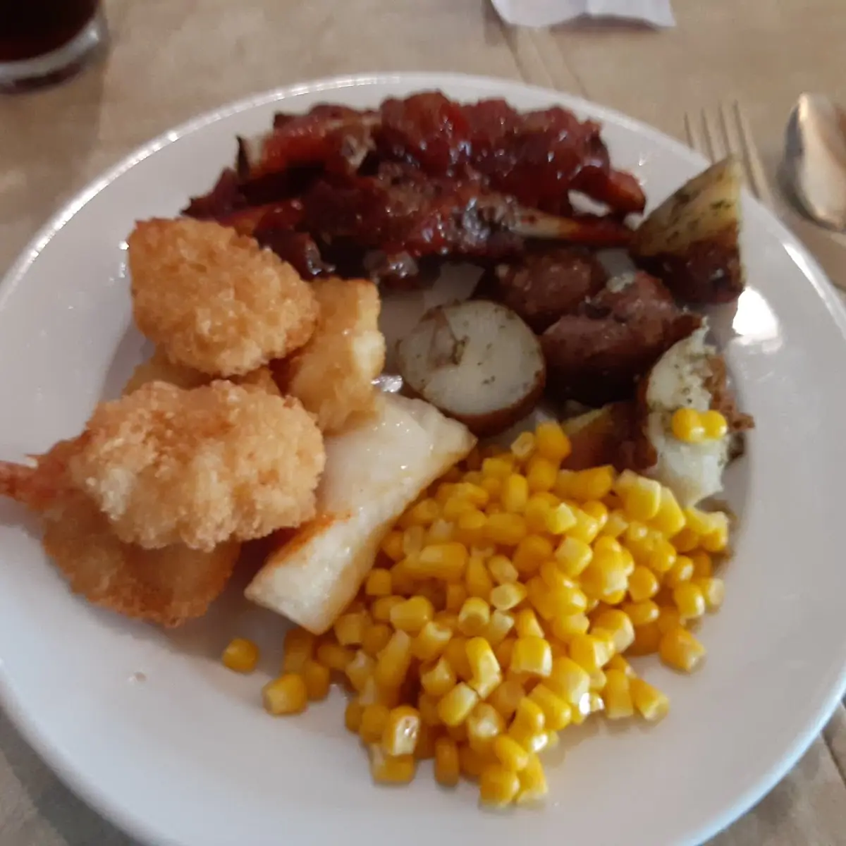 Items from a Buffet Fish Shrimp Ribs