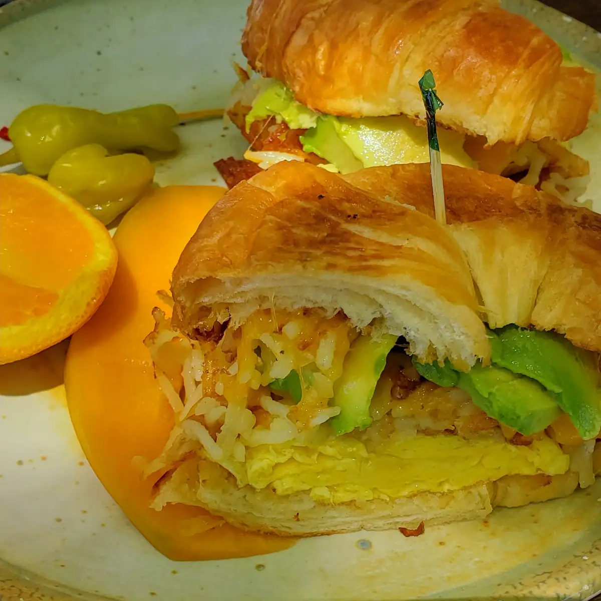 Avocado Egg Breakfast Sandwich with Well Done Hashbrowns Added on Top