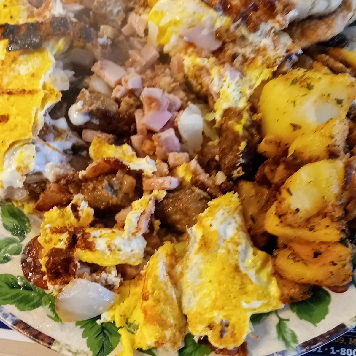 Meat-Lovers Omelette with Corned Beef Hash Also Bacon Ham Sausage Onions Peppers Cheddar