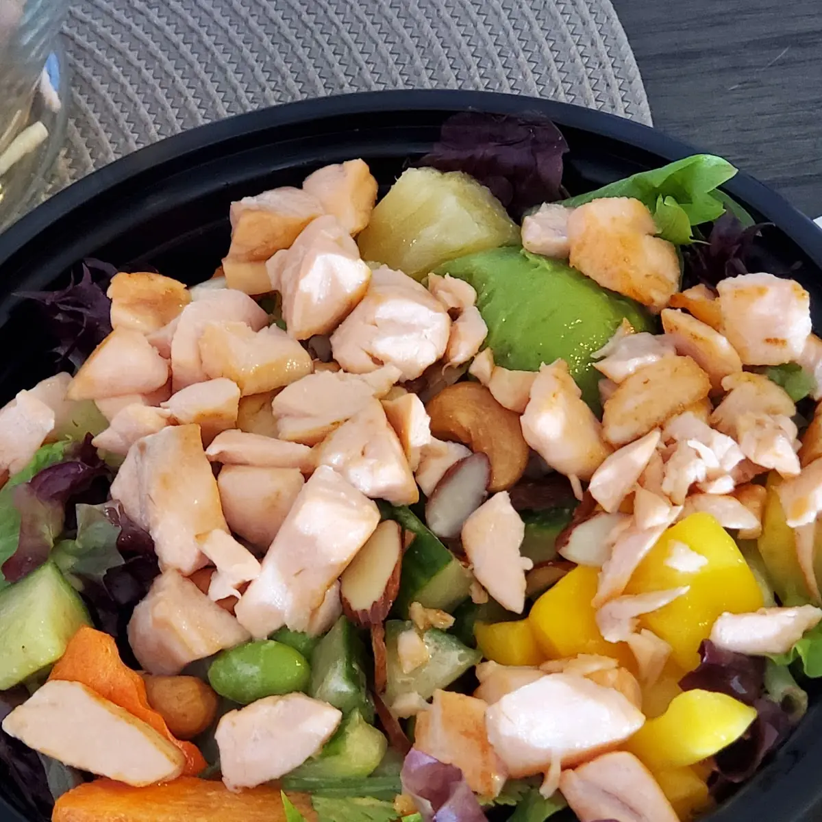 Spring Mix Salmon Edamame Mango Pineapple Carrots Mango Sauce Cashew Poké Bowl