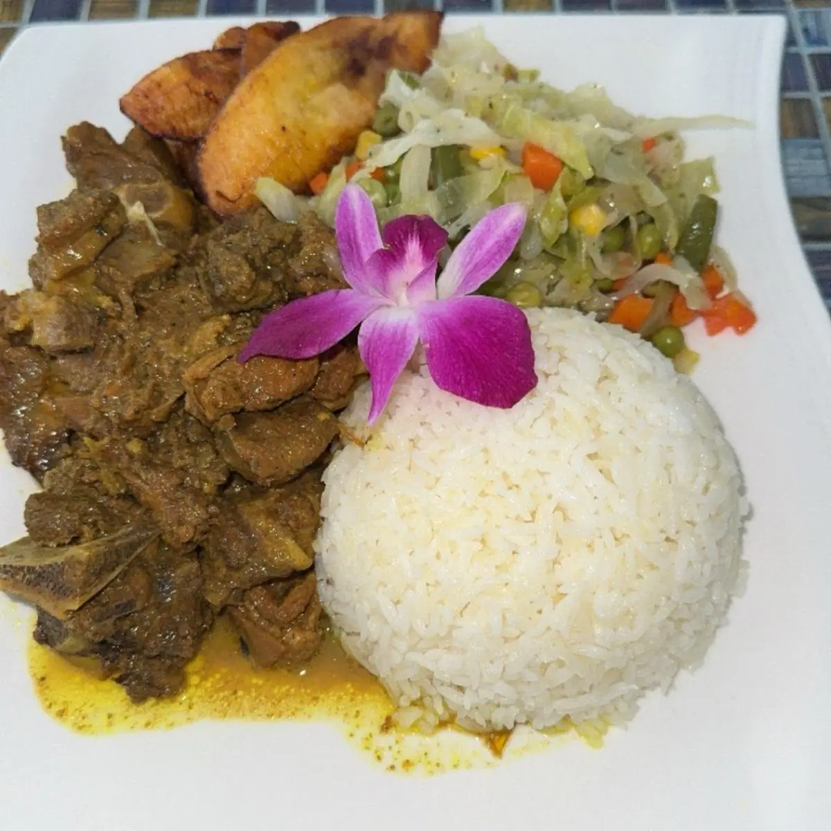 Curry Goat with White Rice Steamed Vegetables & Plantains