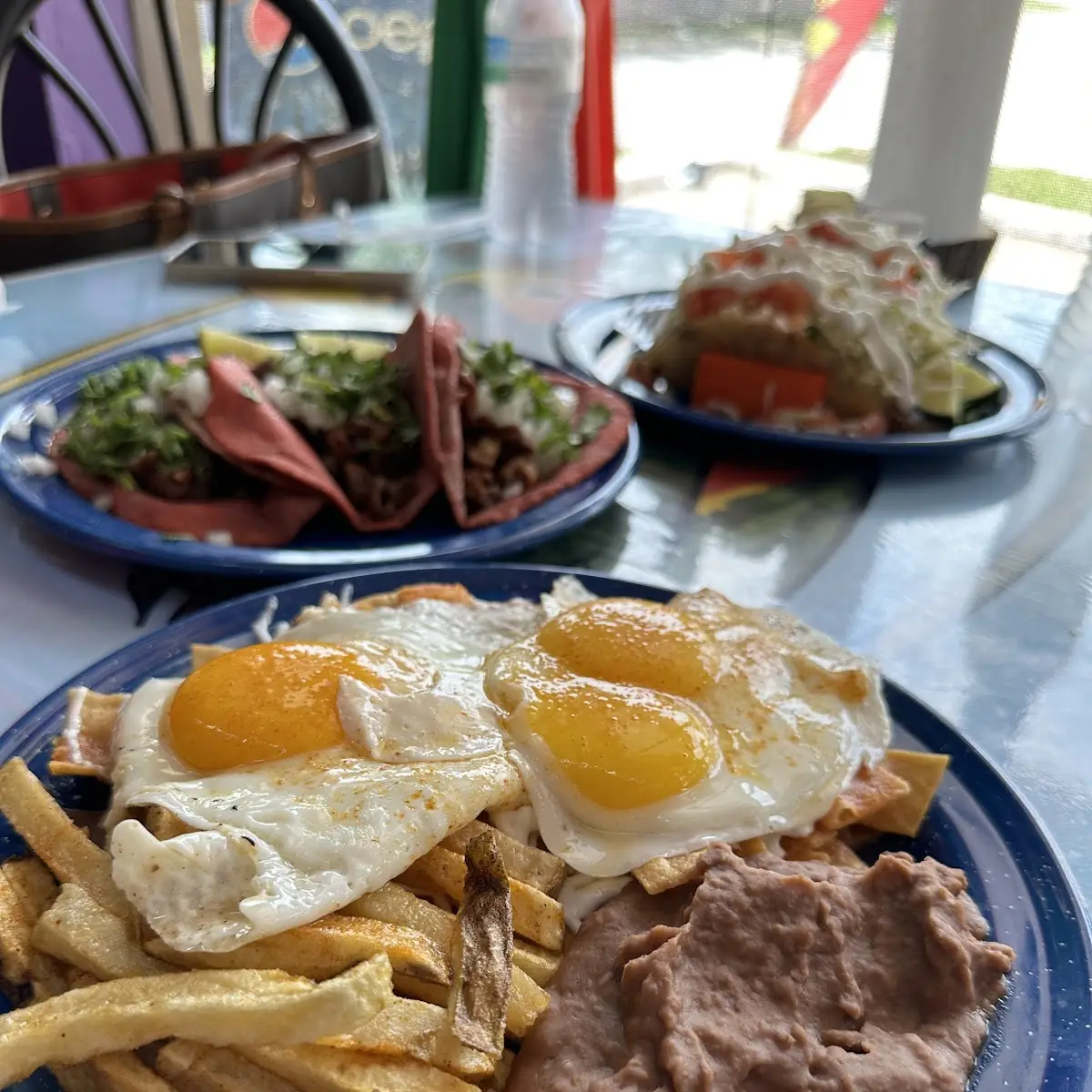 Fried Eggs Chilaquiles with Refried Beans