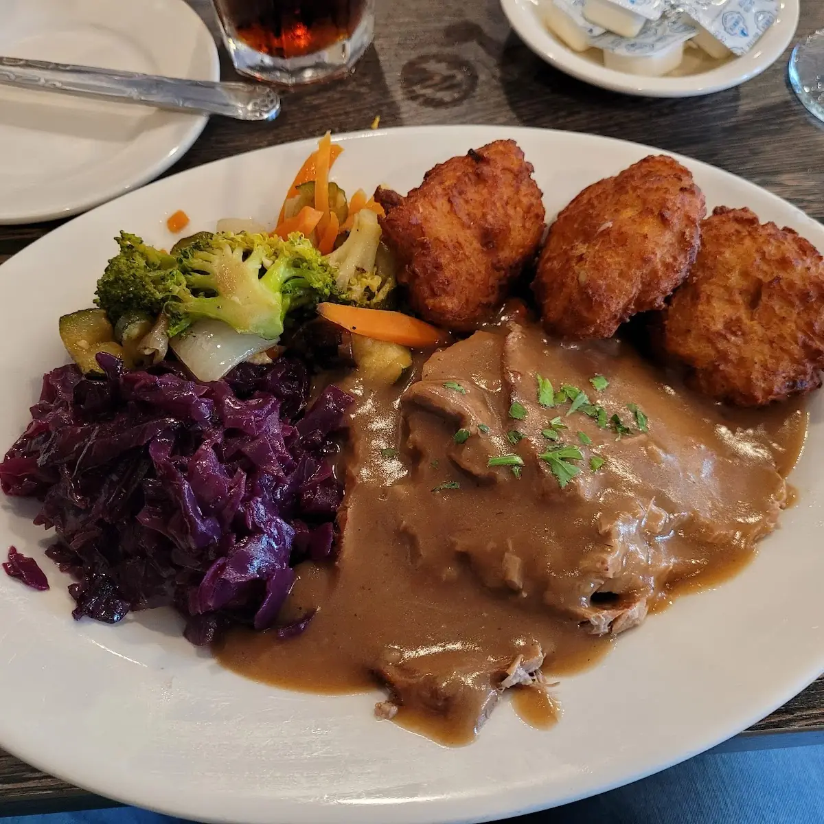 Pot Roast with Potato Pancakes Red Cabbage and Vegetables